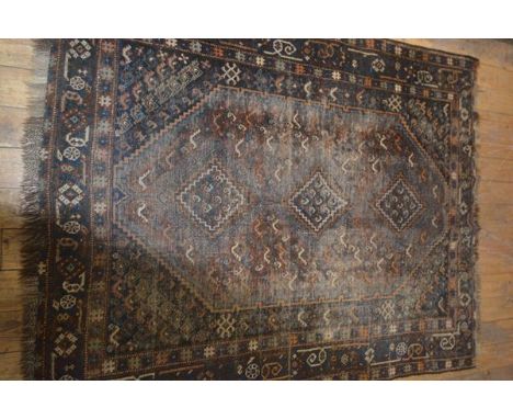 A Turkish carpet, the central field with three diamond shaped medalliions flanked by triple border, worn, 178cm x 141cm