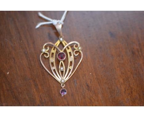 An Art Nouveau pendant with amethyst and seed pearls on yellow metal