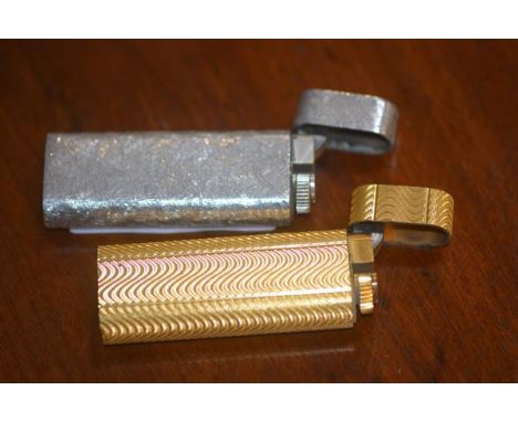 Two Cartier (Paris) Roller gas lighters, one gilt, one white metal (2)