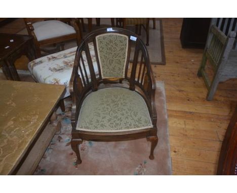An Edwardian inlaid rosewood horseshoe shaped arm chair, upholstered back panel and slats, upholstered seats, on short cabrio