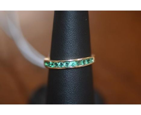 An emerald half hoop eternity ring in 10ct yellow gold, size N/O