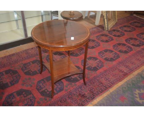 An Edwardian circular rosewood side table, the crossbanded top on square legs with curved ends, shaped under shelf, 69cm x 59