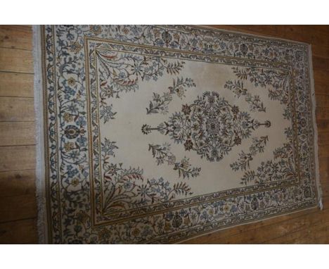 An Indian wool carpet with all over leaf and vine decoration, on ivory field with all over flowerhead vine and leaf decoratio