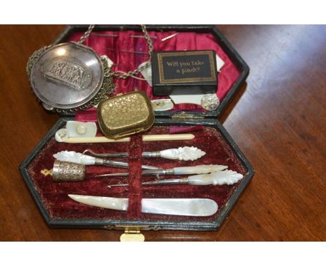 A sewing kit with mother of pearl handled tools in fitted case, a mesh coin purse and papier mache snuff box and a small bras