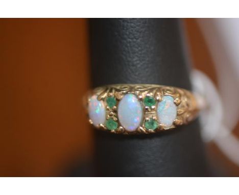 A lady's opal and emerald set dress ring on 9ct gold band