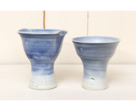 Sheila Casson (British, b.1930): two stoneware studio pottery footed wine cups - in an Oriental style, in a graduated blue an