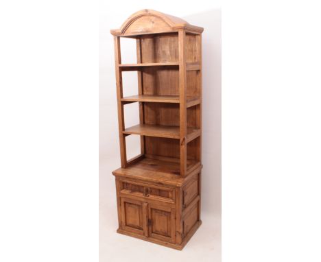 A small pine dresser - modern, the broken arched cornice over three open shelves, the outset base with a drawer above a pair 