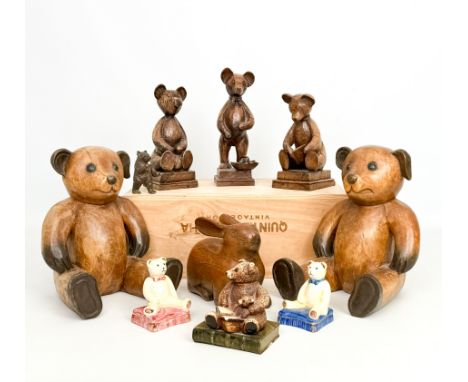 A small collection of carved wooden, china and resin figures of teddy bears - including two large seated carved wooden bears,