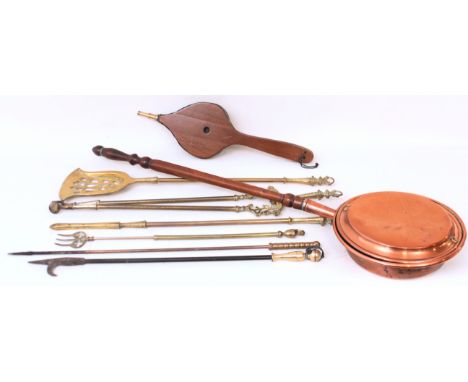 A group of eight antique brass and copper fireside items, comprising - 1. A set of three brass fire irons 2. A brass toasting