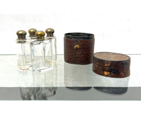 A nested set of silver-plated and cut-glass scent bottles in a fitted leather case - German, by Moritz Madler of Leipzig, ear
