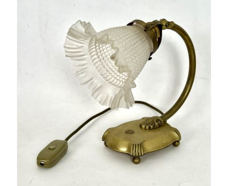 An early 20th century style brass and glass reading lamp - with a moulded, frosted clear glass shade on an adjustable head, r