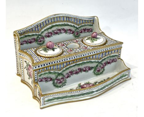 A Sevres style porcelain inkstand - early 20th century, with arched back, two covered inkwells flanking a central quill holde