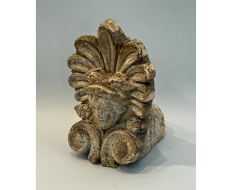 A decorative 19th century buff terracotta roof tile finial - with a classical mask within an anthemion surround above cones a