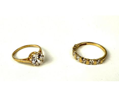 Two 9ct yellow gold stone-set rings - both UK hallmarked, comprising a seven stone CZ half eternity ring, size O; and a singl