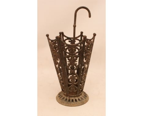 A cast iron umbrella-shaped stick or umbrella stand - with removable drip pan with crook-handle, on a pierced circular base, 