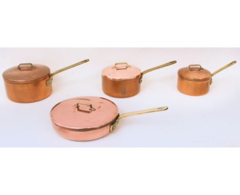 A set of four copper and brass cooking pans - second half 20th century, comprising three saucepans (8 in, 7 in and 6 in diame