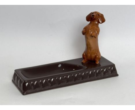 A scarce Beswick begging Dachshund figure mounted on a grey glazed trinket dish - printed and impressed factory marks, 12.5cm