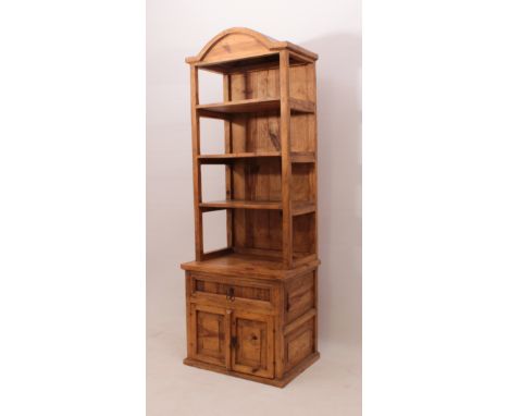 A small pine dresser - modern, the broken-arch cornice over three open shelves, the outset base with a drawer above a pair of