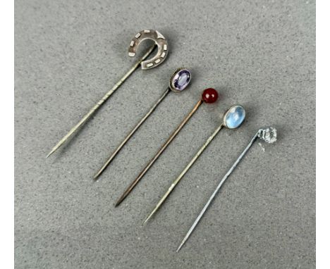 Five vintage stickpins - including two white metal pins set with moonstone and amethyst; a rolled gold and carnelian pin; a w