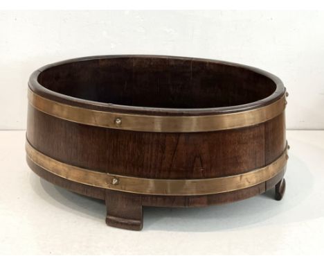 A brass bound mahogany oval planter by R. A. Lister &amp; Co. Ltd, Dursley - slightly tapered form with four bracket feet, in