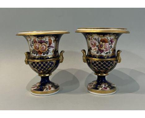 A pair of 19th century Coalport two handled vases - of campagna urn form, painted with shaped reserves of flowers and gilt di