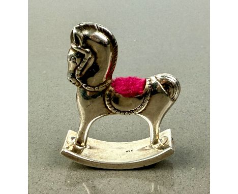 A modern sterling silver novelty rocking horse pin cushion - stamped 925, 5cm high, gross weight 14g.