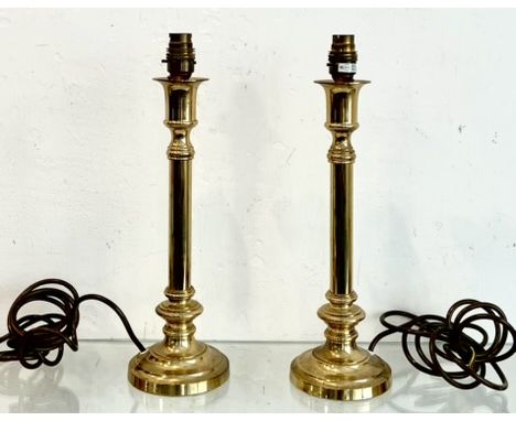 A pair of brass table lamps - of turned candlestick form, 33.5cm high plus fittings (no shades, plugs removed).