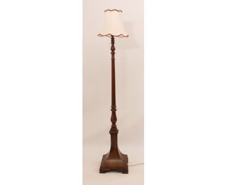 A mid-century walnut standard lamp - 1930s, with turned and fluted column, on a flared square pedestal base with ogee feet, 1