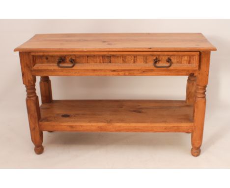 A pine hall or console table - with a moulded top over a single full-width drawer with iron handles, raised on ring turned an