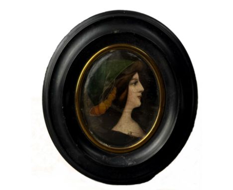 A decorative 19th century oval printed portrait miniature of a lady - Continental, in an ebonised frame, overall 12.6 x 11.2c