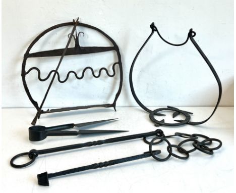 Three 19th century down hearth irons - all in wrought iron, comprising a harnen stand (oat cake dryer or toaster), 37cm high;