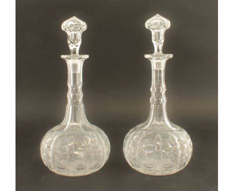 A pair of Victorian cut glass shaft and globe decanters - 27cm high inc. stoppers.