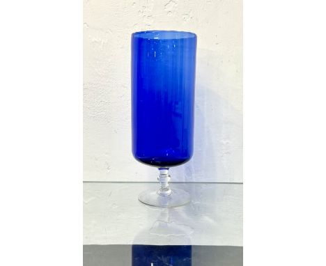 An unusual tall, blue glass pedestal vase - late 19th century, the slightly fluted, cylindrical bowl on a clear glass knopped