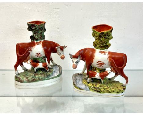 A closely matched mirrored pair of 19th&nbsp;century Staffordshire cow and calf spill vases &ndash; 27cm high, one with small