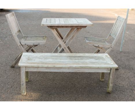 A four-piece suite of hardwood garden furniture - a folding table (LWH 70 x 80 x 76.5 cm), two folding chairs and a low table