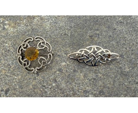 Two silver Celtic style brooches - one with Edinburgh hallmarks, 1968, set with a central round cut citrine, 3.6cm diameter; 