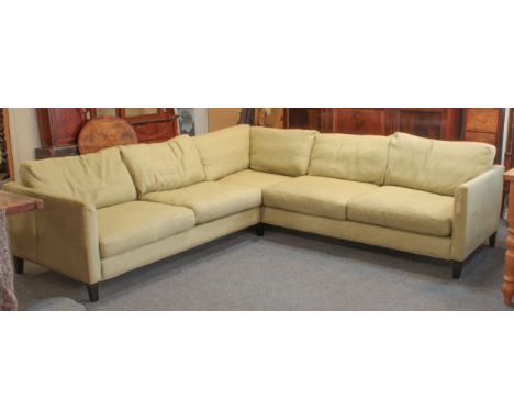 A large pale green upholstered corner sofa by Zaparoh (sofa.com) - three-part, with angular back and arms and feather cushion