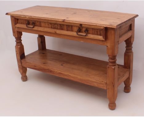 A pine hall or console table - with a moulded top over a single full-width drawer with iron handles, raised on ring turned an