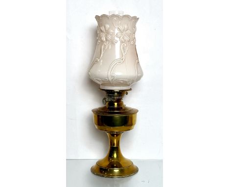 An antique brass oil lamp with moulded pink glass shade - with Eltax burner, the tulip-shaped, shaded pale pink to white opaq