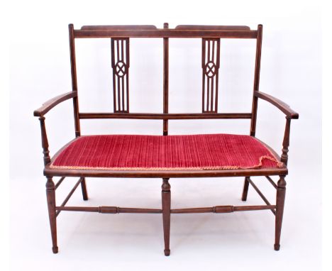 A boxwood-lined chair-back settee - early 20th century, the double-square back with pierced splats over a burgundy upholstere