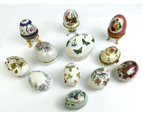 Twelve porcelain and bone china collectors eggs - including examples by Wedgwood, Limoges and Masons, four with gilt metal mo