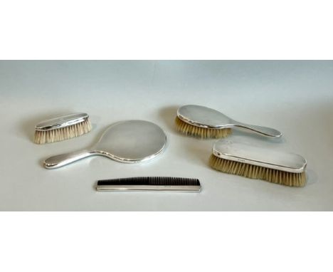 A George VI four piece silver dressing table set - maker TP, London 1944, engine turned, comprising a hand mirror, clothes an