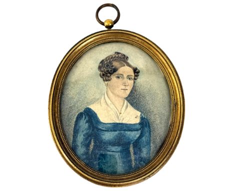 A portrait miniature of a lady - mid-19th century, watercolour on card, oval, wearing a blue low-cut dress with white blouse,