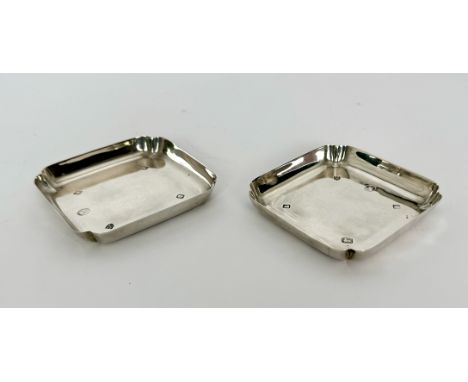 A pair of Elizabeth II Jubilee silver trinket dishes - Tessiers Ltd, London 1977, square form with everted corners, 9.25cm sq