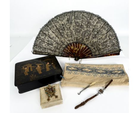 A Victorian tortoiseshell mourning fan - in ivory silk and black lace with flowers, foliage and rocaille, with plain tortoise