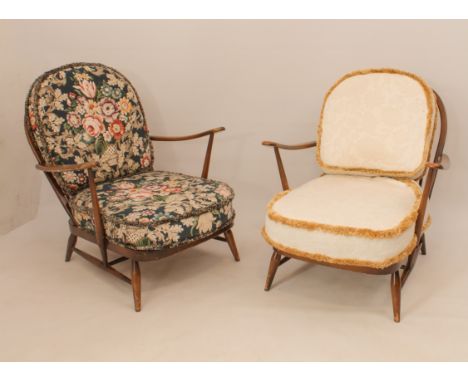 Two Ercol model 203 beech wood easy armchairs - with spindle backs, manufacturer's foil labels to back of seats, one upholste