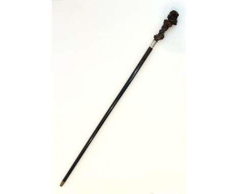 An Edwardian white metal mounted carved rootwood and rosewood walking cane - the polished rootwood knop carved with a number 