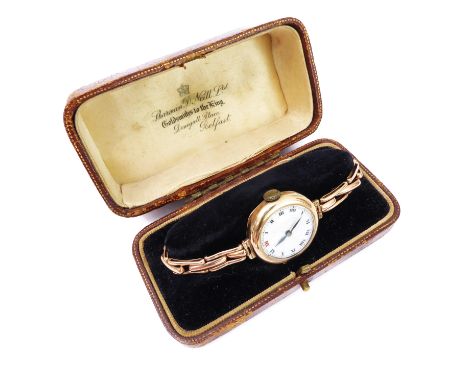 A lady's 9ct rose gold cased wristwatch - with expandable 9ct rose gold bracelet, the white dial (hairlines emanating from ce