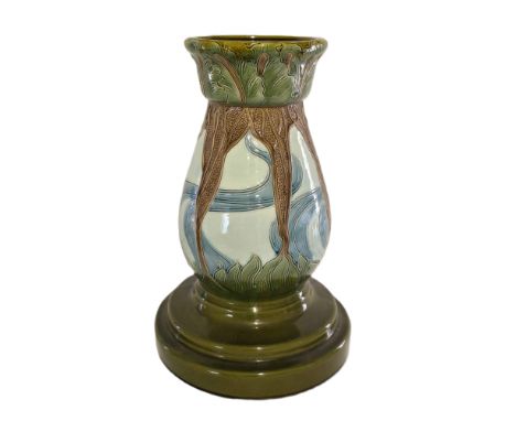 A Burmantofts Jardinière stand. The Secessionist baluster stand is decorated in blues, brown and green, with a foliate design