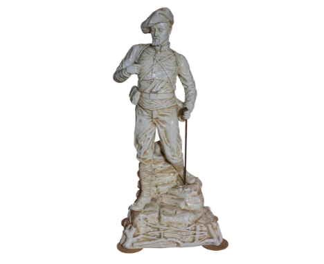 A large Bretby Art pottery Boer War figure wearing a Scottish uniform, stood on a rocky outcrop. This rare figure retains the